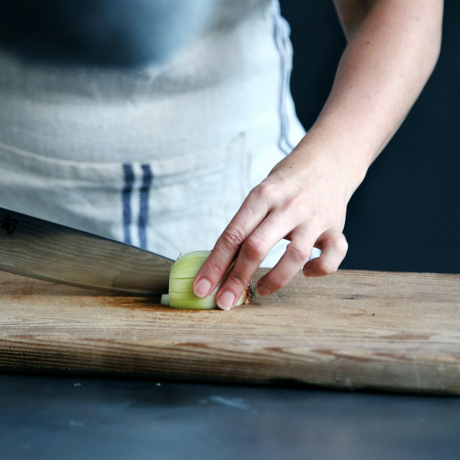 Community members collaborating in a modern kitchen space, exchanging recipes and cooking techniques